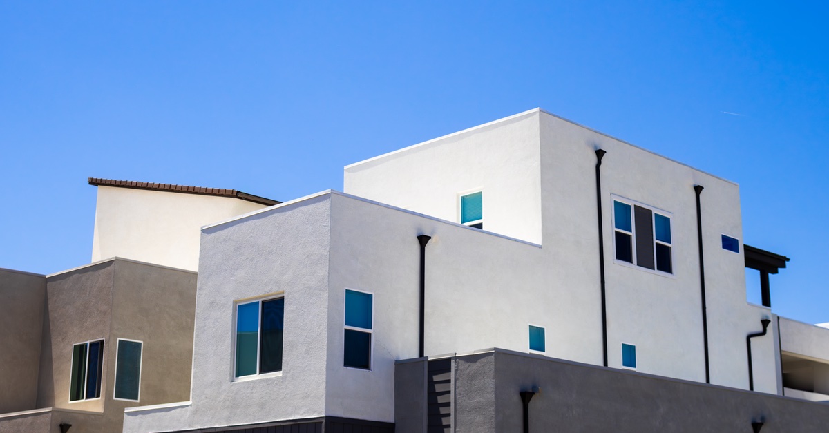 Completed exterior house painting showing a fresh white facade