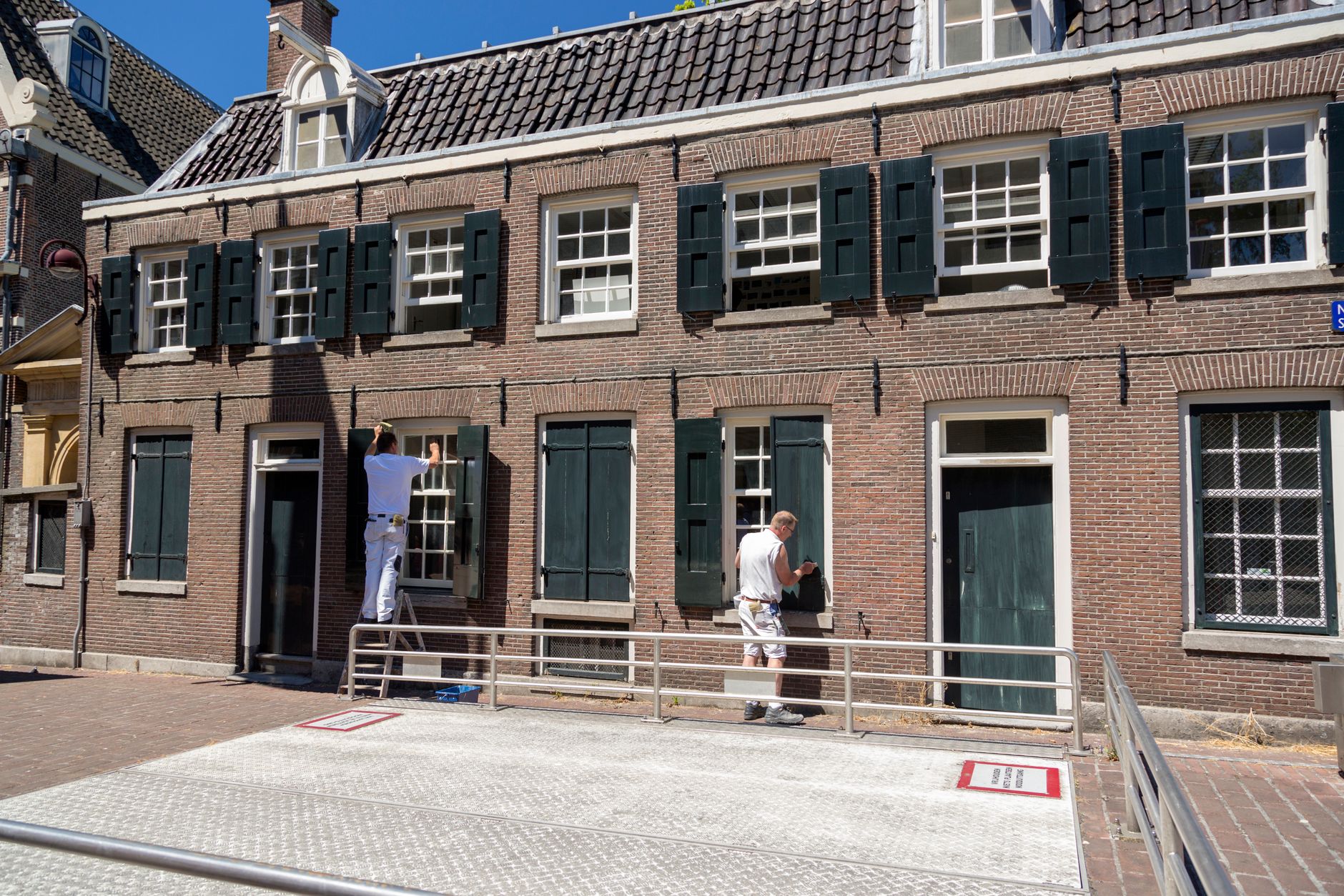 A painter working on a house exterior